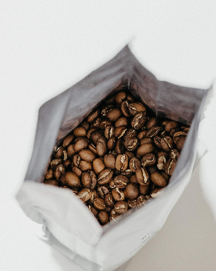 Roasted coffee beans in open bag before shipping.